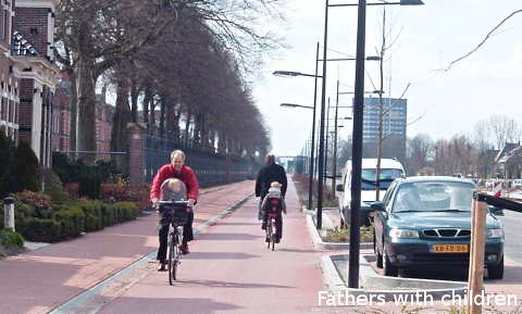 Fathers cycling with their children